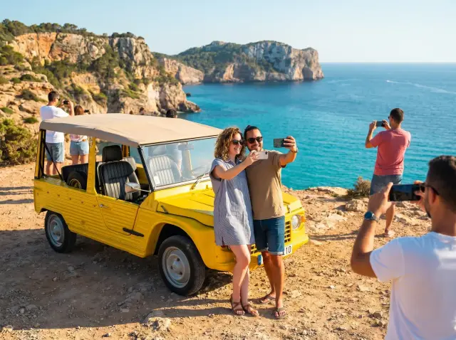 Mehari tour photo stop at Ibiza clifftop with turquoise Mediterranean sea — Retro Rides