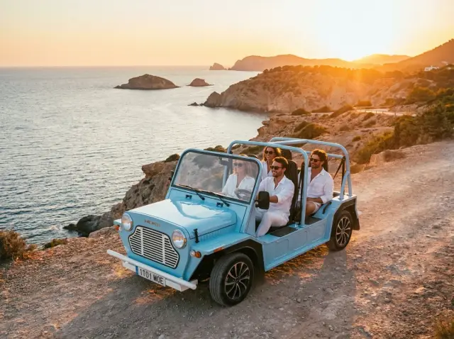 Light blue Kate electric beach car guided tour on Ibiza coastal road — Retro Rides