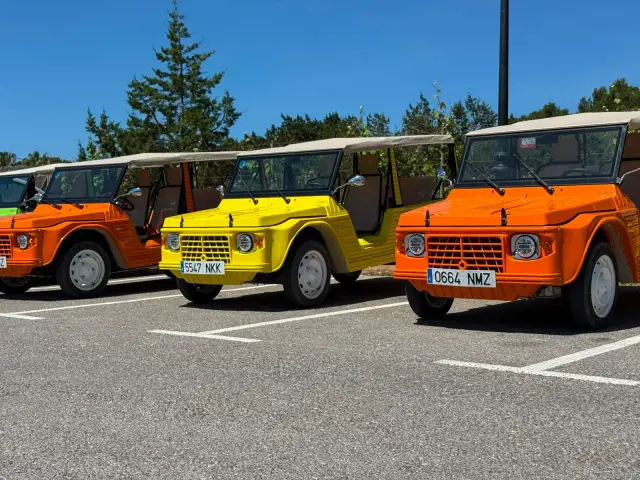 Retro Rides eStory electric Mehari fleet in orange and yellow at Ibiza parking base — Spanish plates, Retro Rides