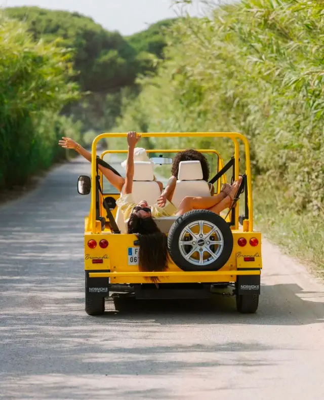 Yellow Kate electric Moke beach car on scenic Ibiza road — Retro Rides open-air tour